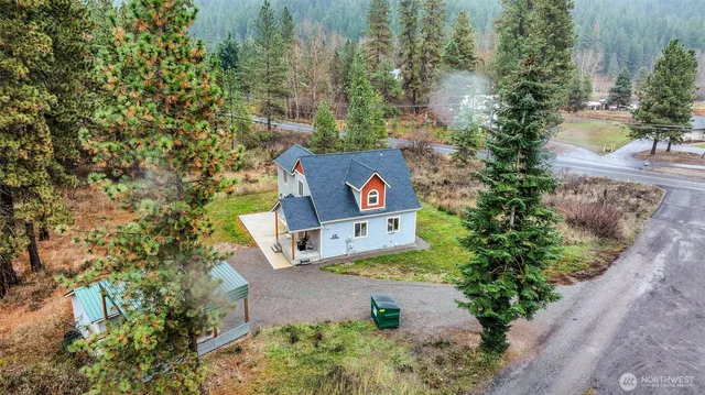 an aerial view of a house with a yard