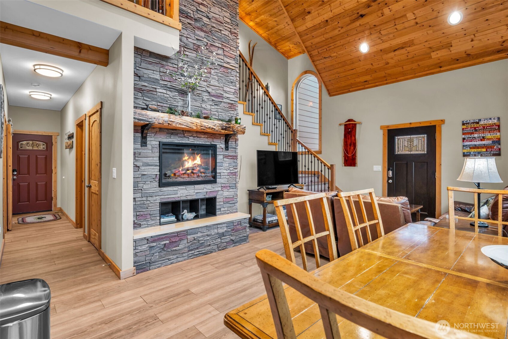 11650 Eagle Creek Road Leavenworth, WA 98826 - Photo 8 of 38 a living room with furniture a flat screen tv and a fireplace