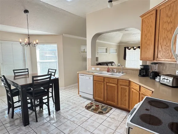 a kitchen with stainless steel appliances kitchen island granite countertop a sink and cabinets