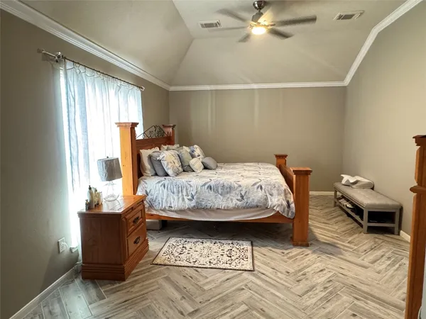 a bedroom with furniture and a window