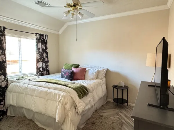 a bed sitting in a bedroom next to a window