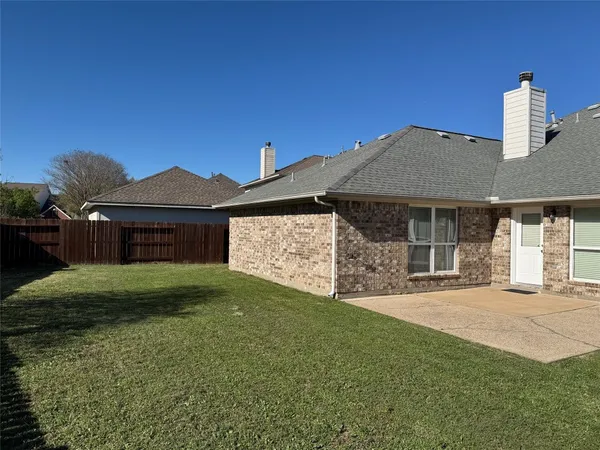 a front view of a house with a garden and yard