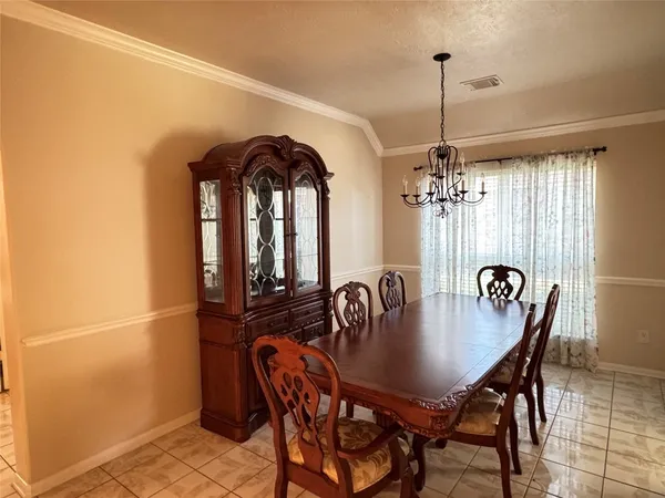 a view of a dining room with furniture and chandelier