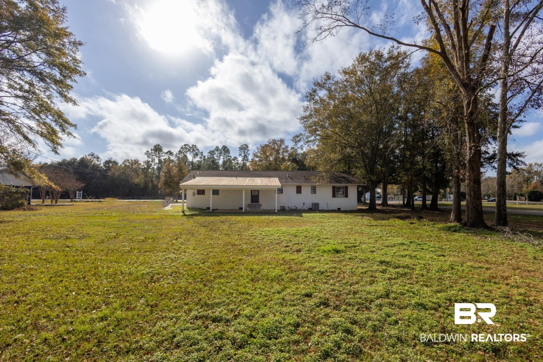 18267 Highway 98 Foley, AL 36535 - Photo 23 of 26 Back of property featuring a patio area, a lawn, and a metal roof
