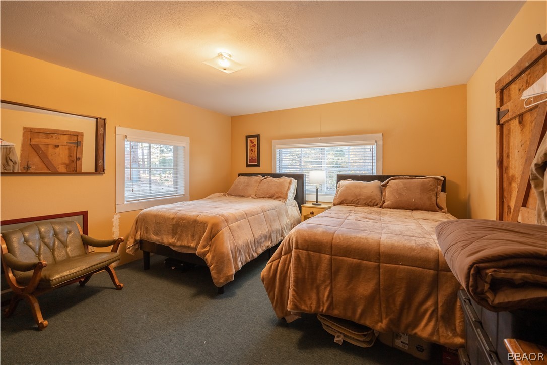 32 Big Bear Boulevard Big Bear Lake, CA 92315 - Photo 31 of 41 a spacious bedroom with two beds and a couch