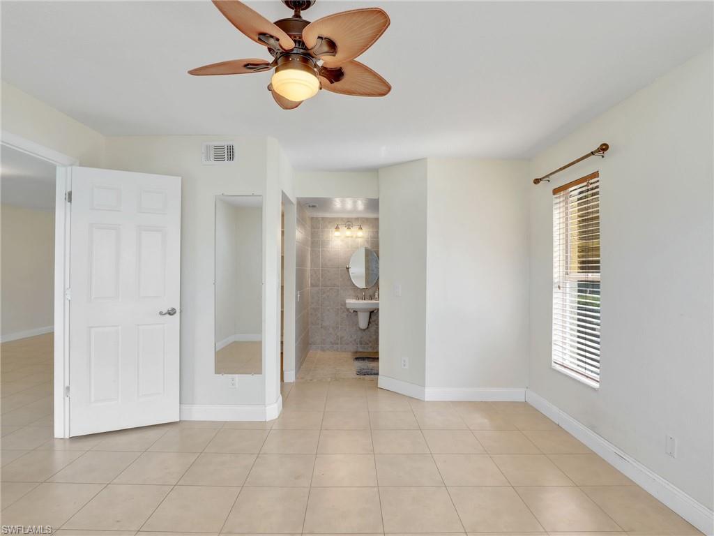 744 Landover Circle, Unit 101 Naples, FL 34104 - Photo 11 of 24 a view of an empty room with a window
