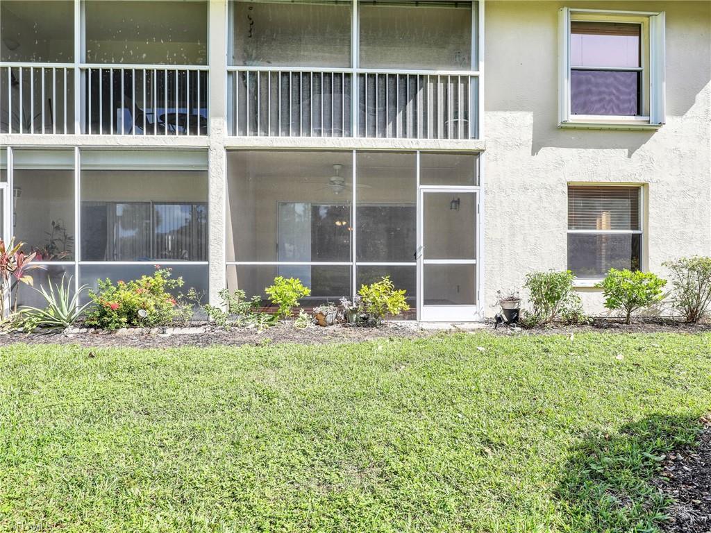 744 Landover Circle, Unit 101 Naples, FL 34104 - Photo 20 of 24 a view of a house with a garden