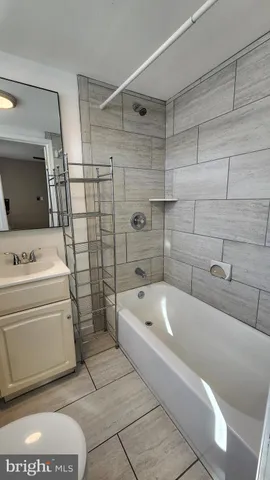 a bathroom with a sink a toilet and bathtub