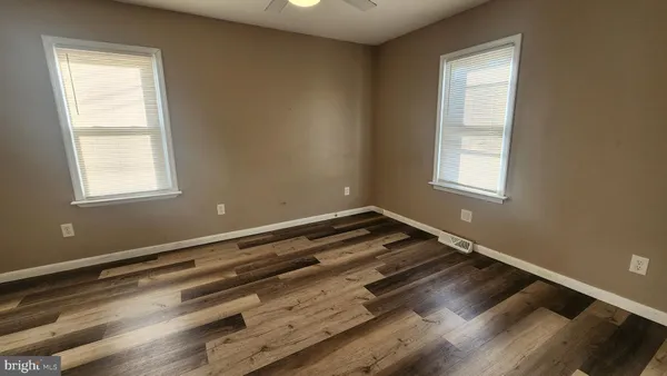 a view of wooden floor and windows in a room