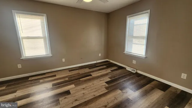 a view of wooden floor and windows in a room