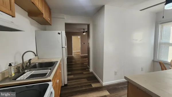 a kitchen with sink a stove and refrigerator
