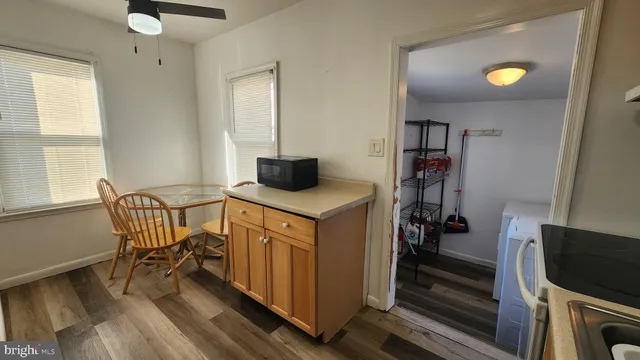 a utility room with wooden floor and furniture