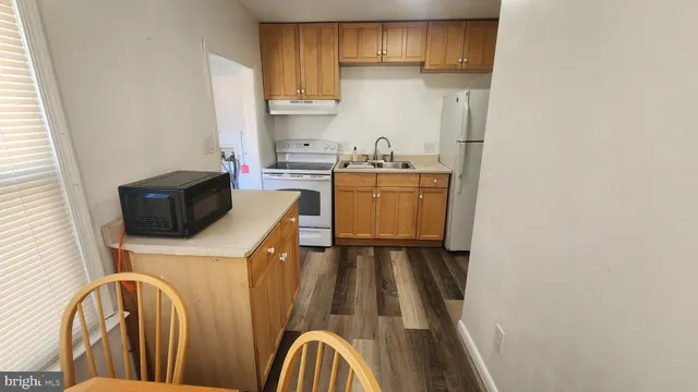 a kitchen with a refrigerator a stove top oven a sink and dishwasher