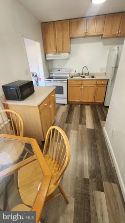 a kitchen with a sink and wooden cabinets