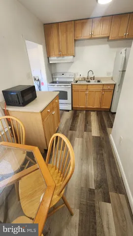 a kitchen with a sink and wooden cabinets