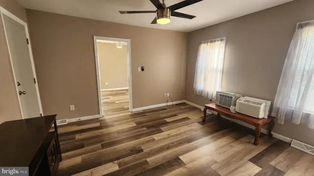 a living room with wooden furniture and a window