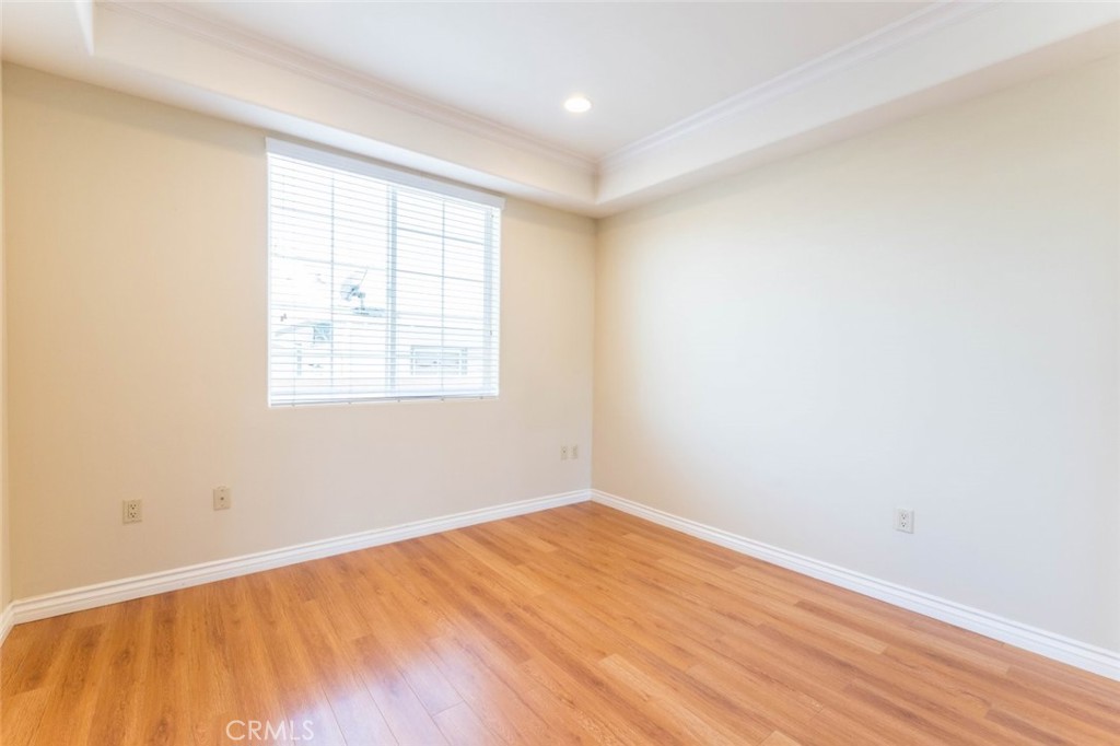 511 East Harvard Road, Unit 101 Burbank, CA 91501 - Photo 17 of 29 an empty room with wooden floor and windows