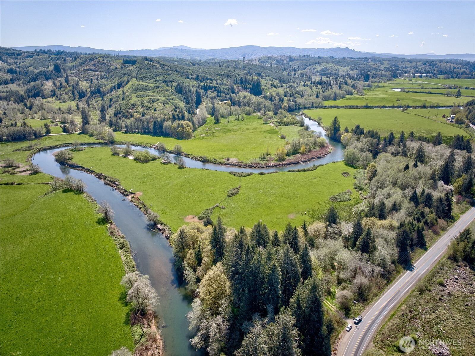 3987 West Sr4 Grays River Grays River, WA 98621 - Photo 2 of 12 an aerial view of a golf course with a lake