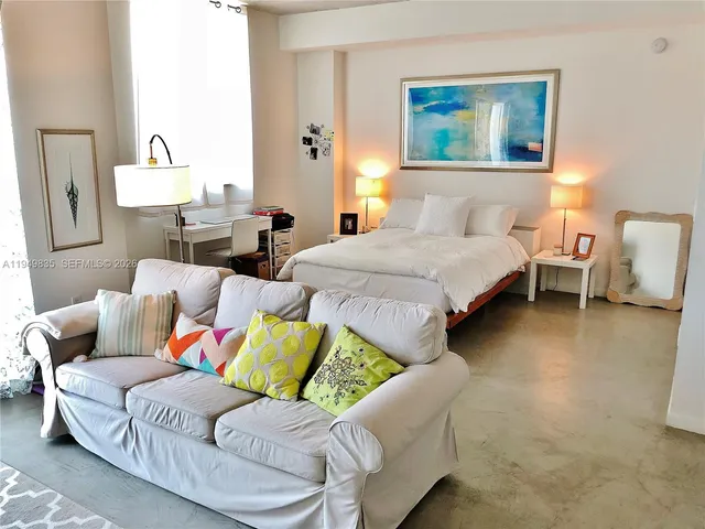 a living room with furniture and a lamp