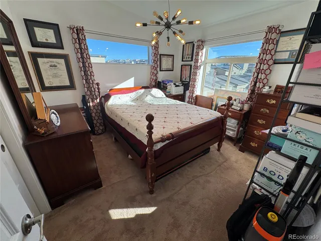 a bedroom with a bed next to a window