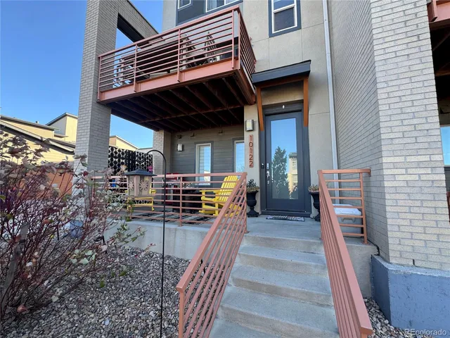 a view of a house with barbeque and wooden stairs