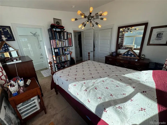 a living room with furniture and a book shelf