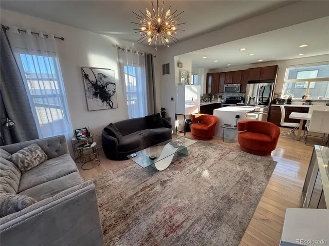 a living room with furniture or couch and a chandelier