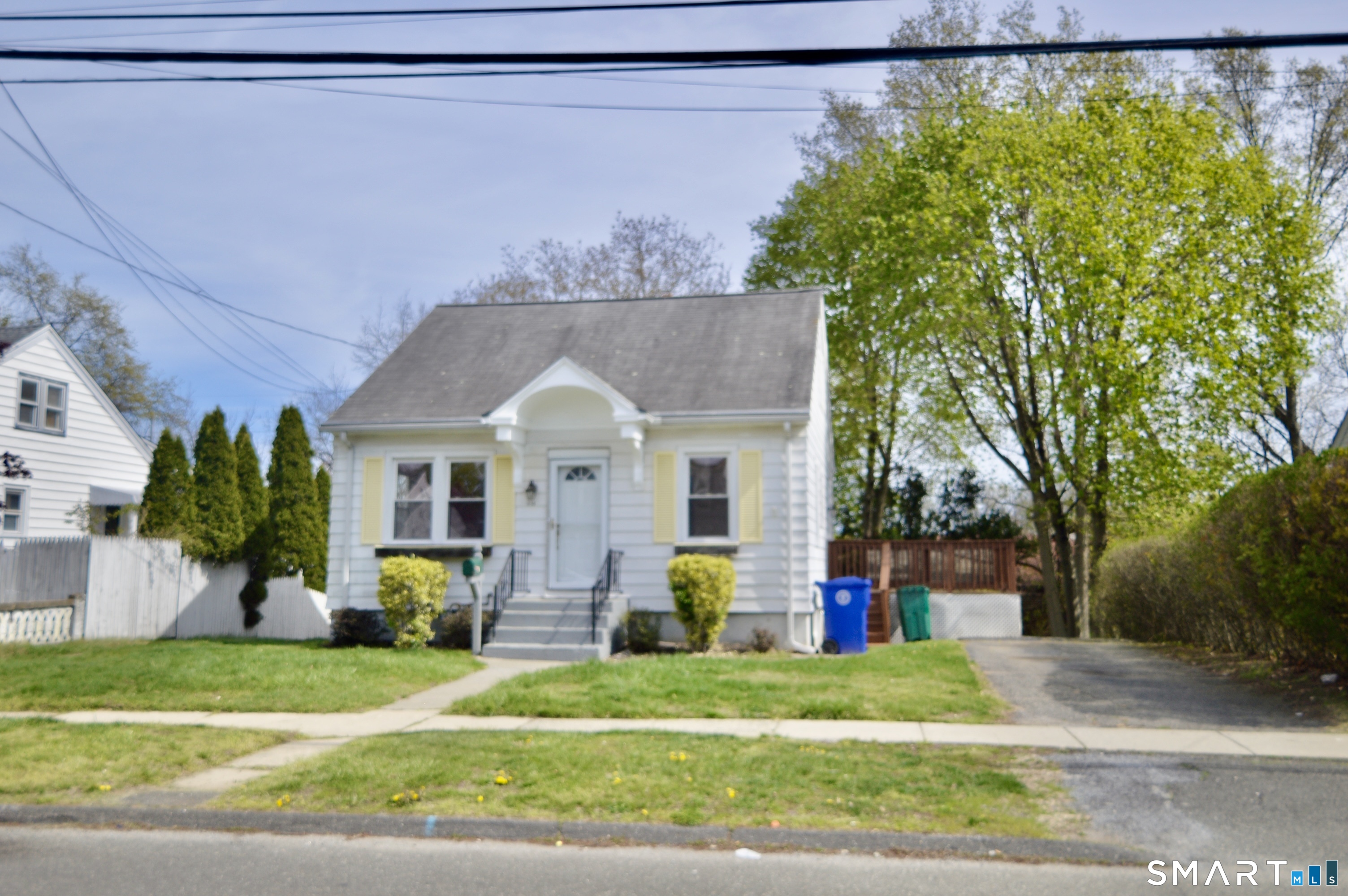 314 Knowlton Street Stratford, CT 06615 - Photo 1 of 26 a front view of a house with a yard and garage
