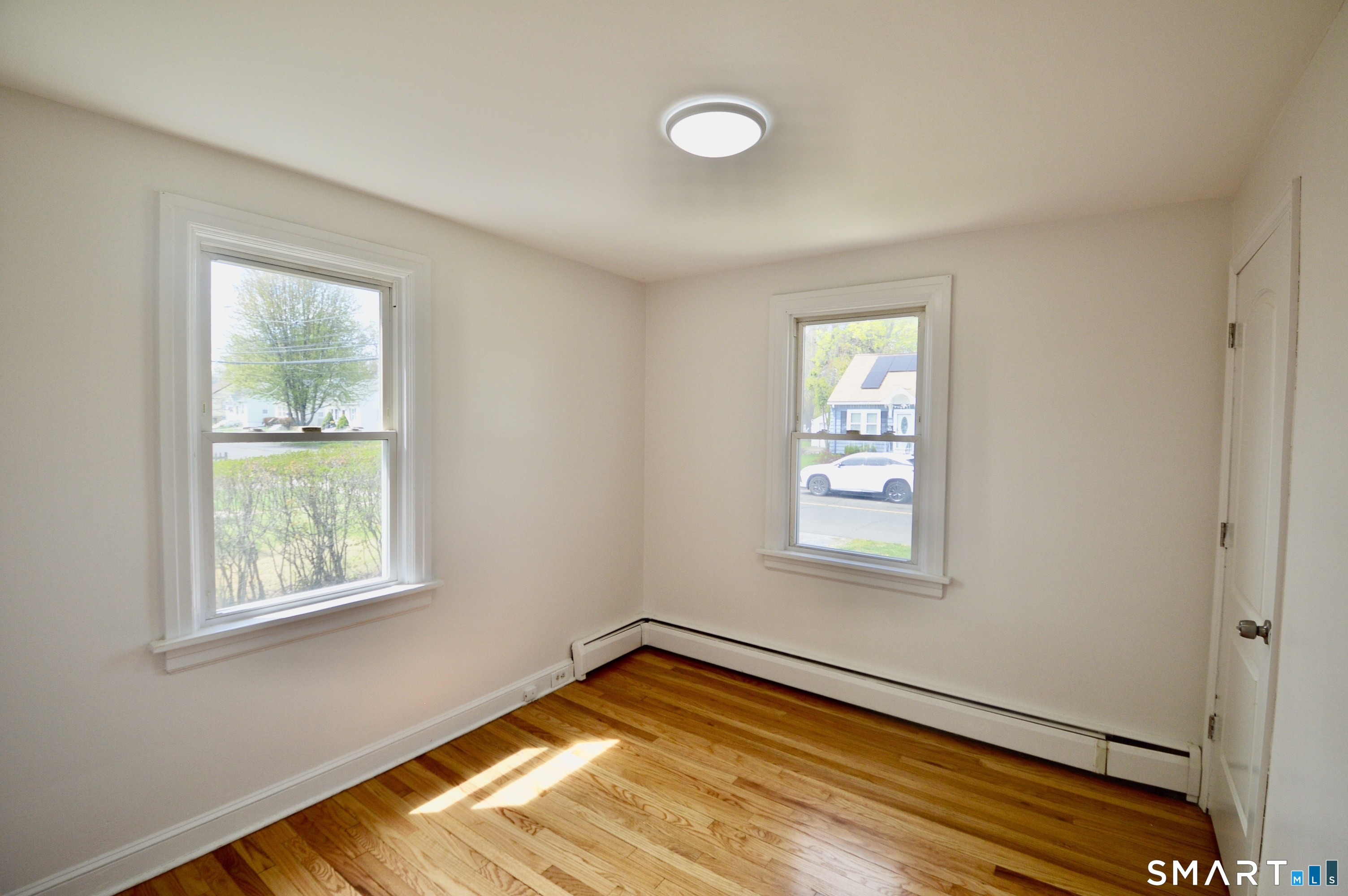 314 Knowlton Street Stratford, CT 06615 - Photo 12 of 26 a view of a room with wooden floor and windows