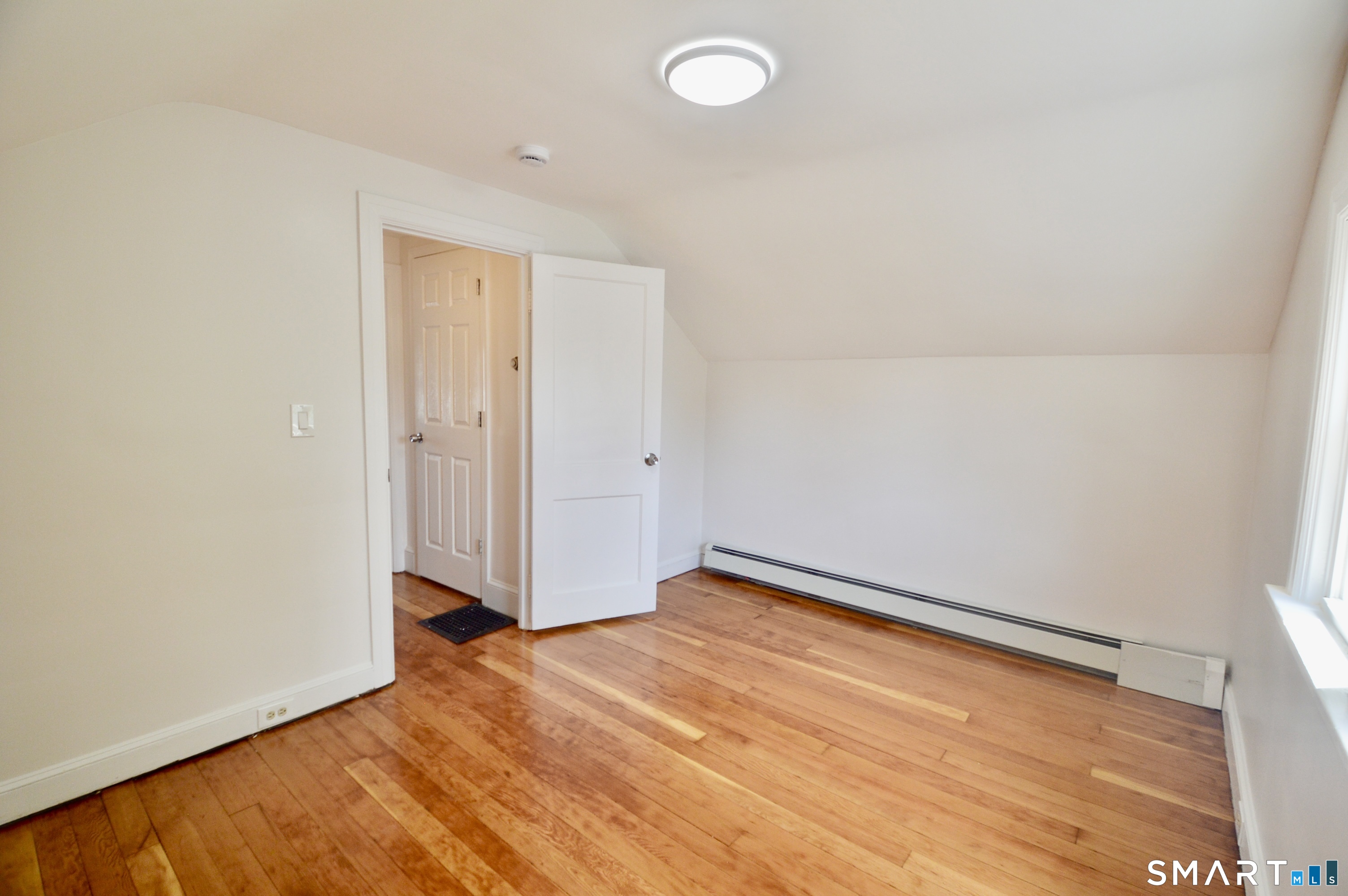 314 Knowlton Street Stratford, CT 06615 - Photo 15 of 26 an empty room with wooden floor