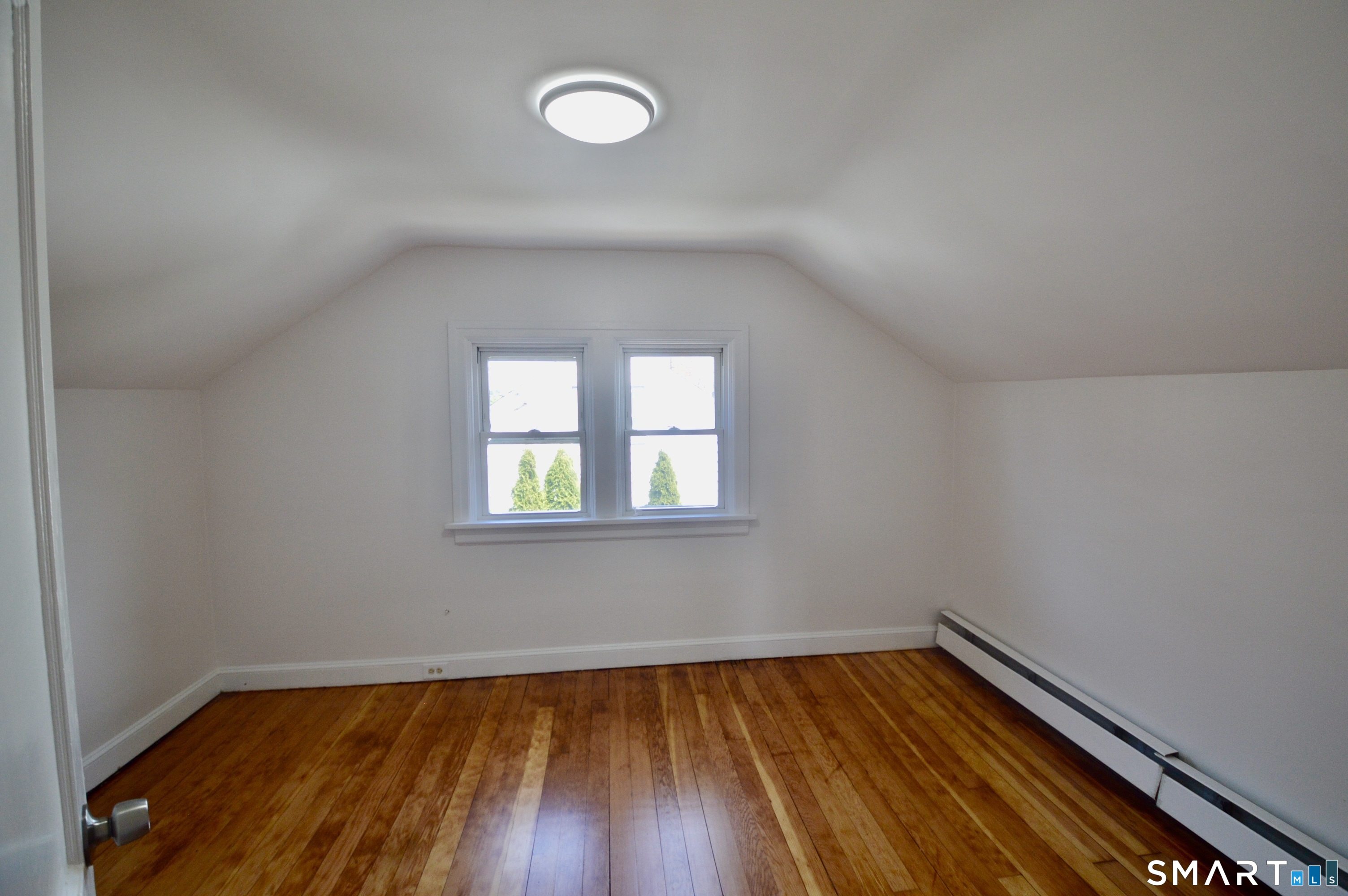 314 Knowlton Street Stratford, CT 06615 - Photo 16 of 26 a view of a room with wooden floors and window