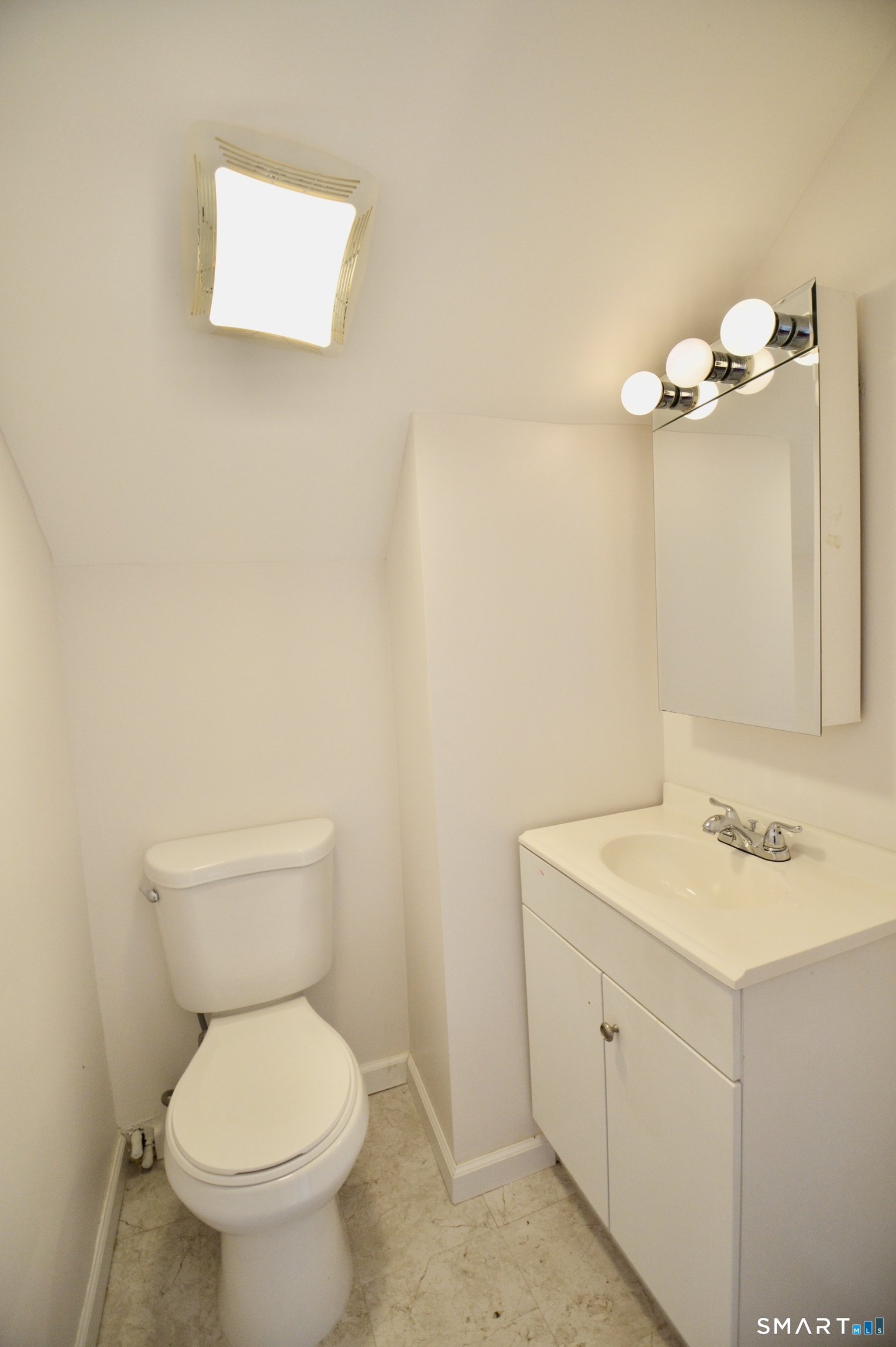 314 Knowlton Street Stratford, CT 06615 - Photo 18 of 26 a bathroom with a sink mirror and toilet