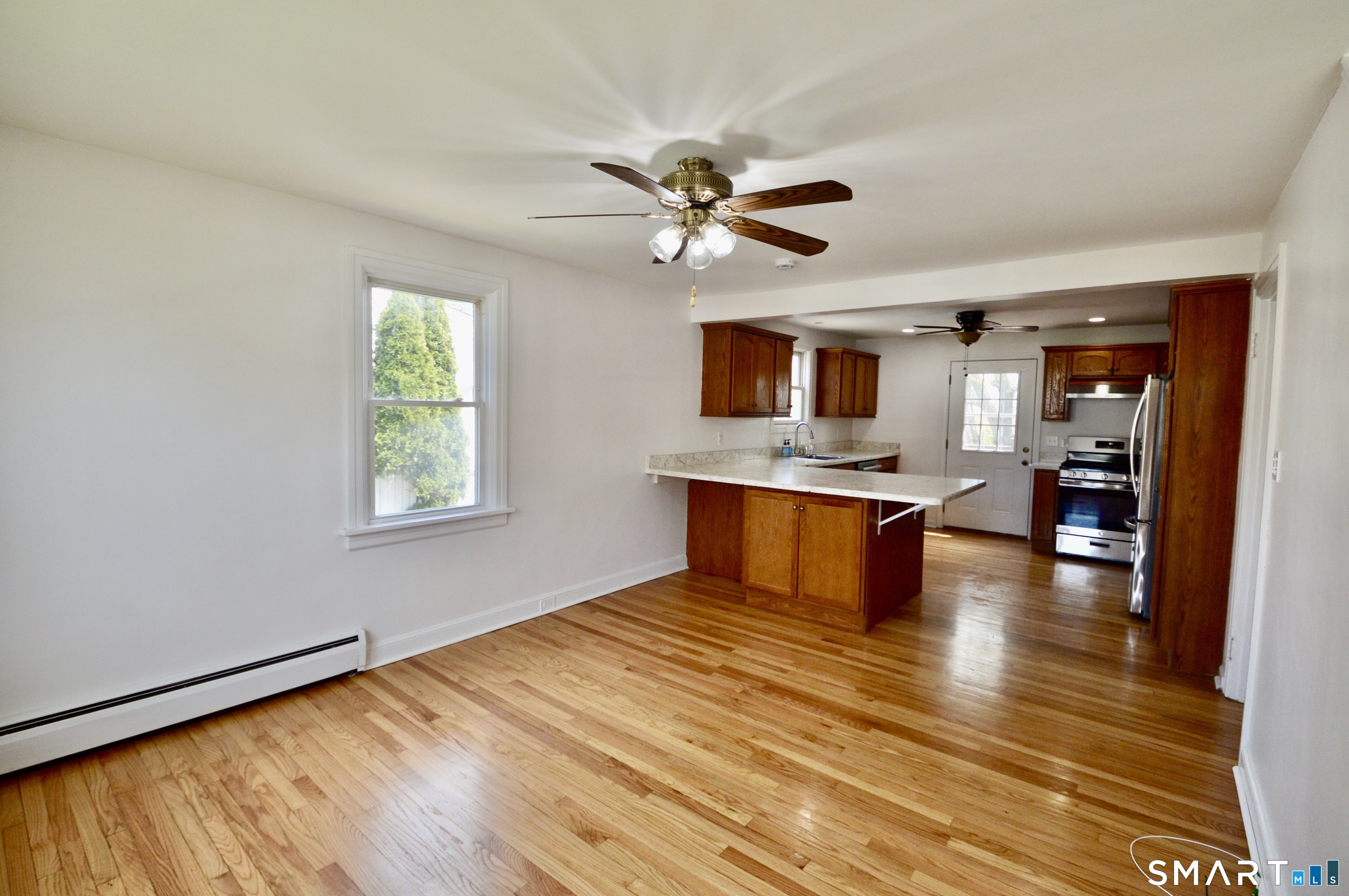 314 Knowlton Street Stratford, CT 06615 - Photo 3 of 26 a kitchen with stainless steel appliances granite countertop a sink dishwasher and a stove with wooden floor