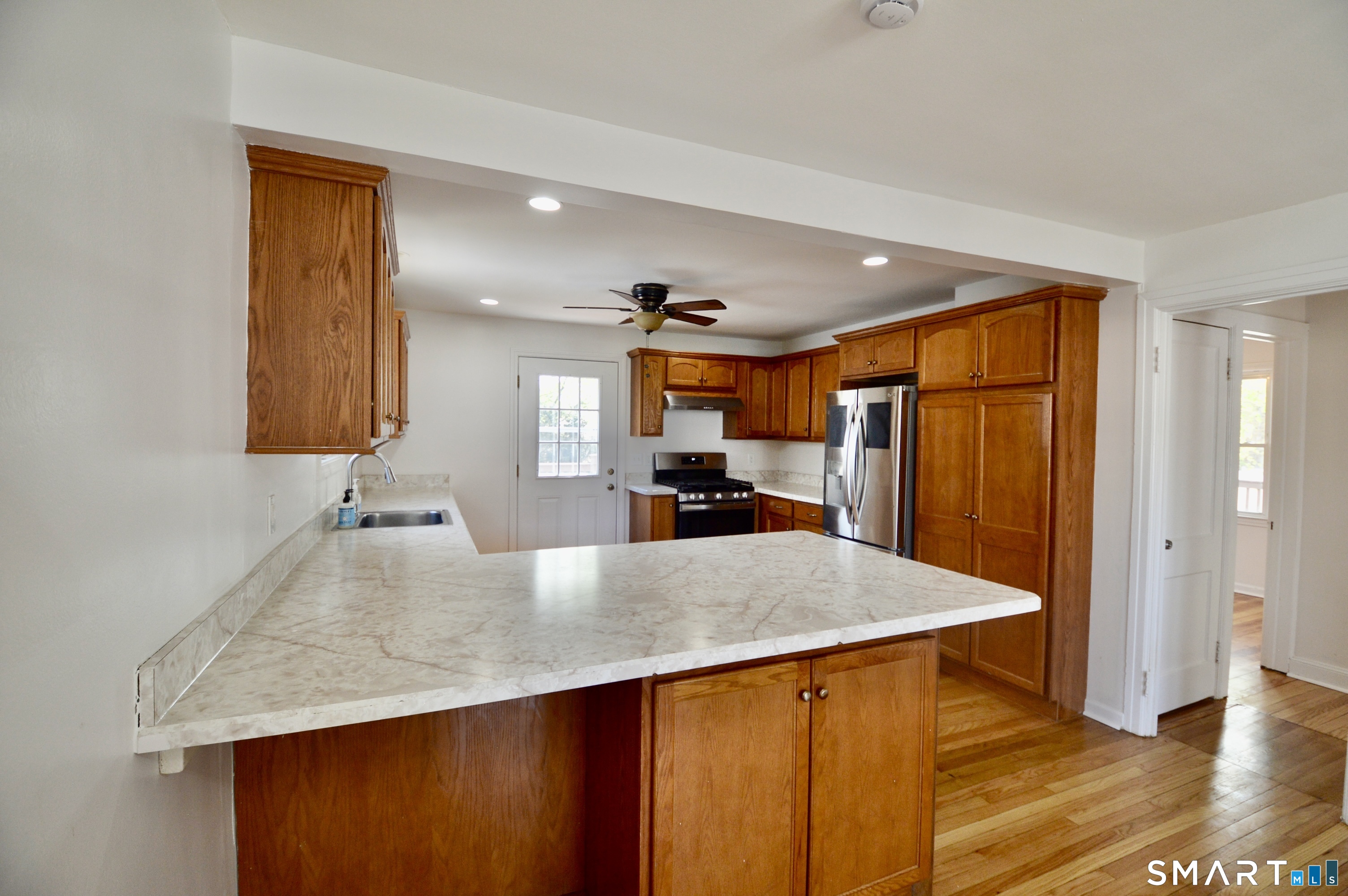 314 Knowlton Street Stratford, CT 06615 - Photo 6 of 26 a kitchen with stainless steel appliances granite countertop wooden cabinets and a granite counter top