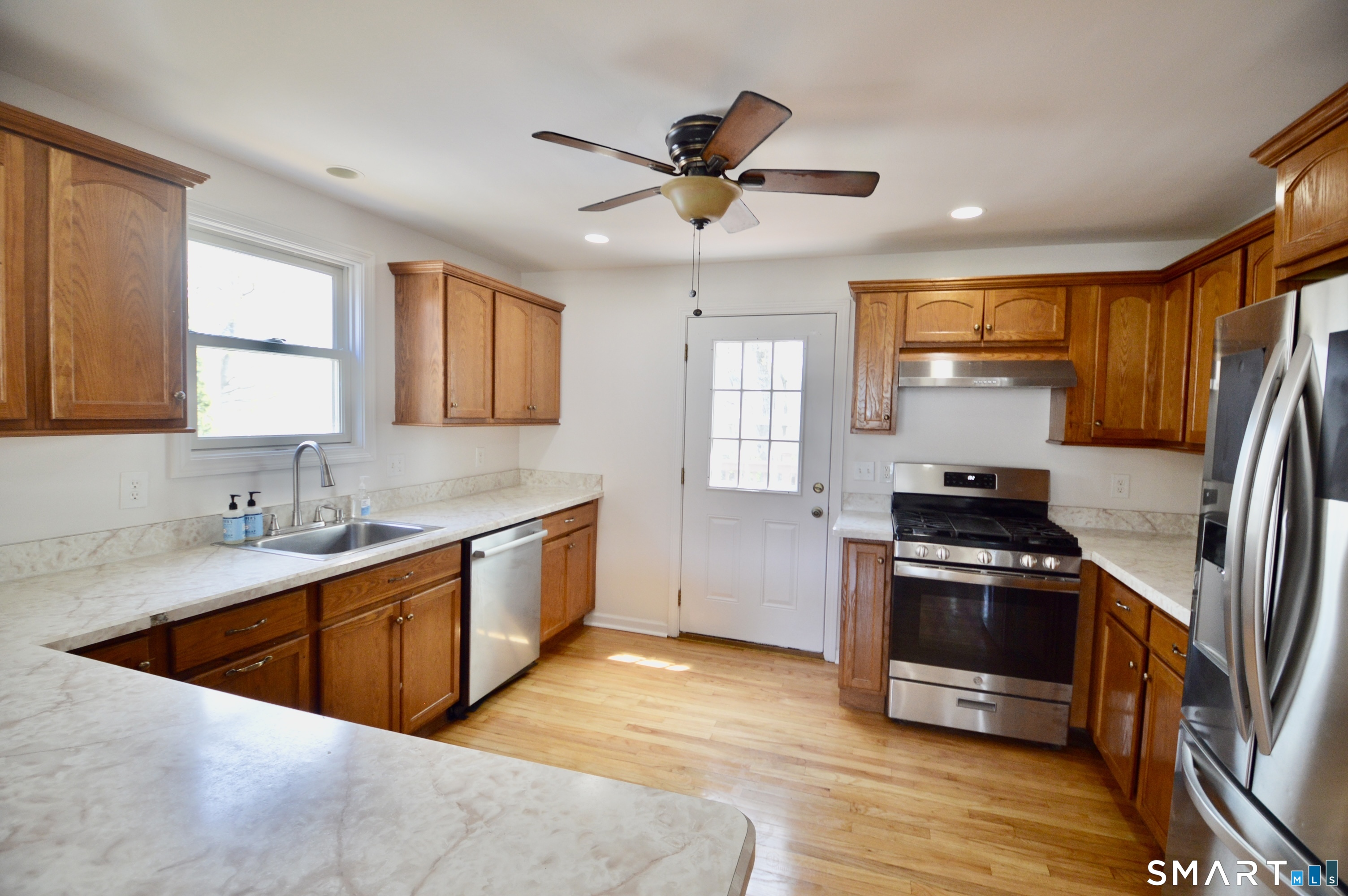 314 Knowlton Street Stratford, CT 06615 - Photo 7 of 26 a kitchen with stainless steel appliances granite countertop a sink stove and refrigerator