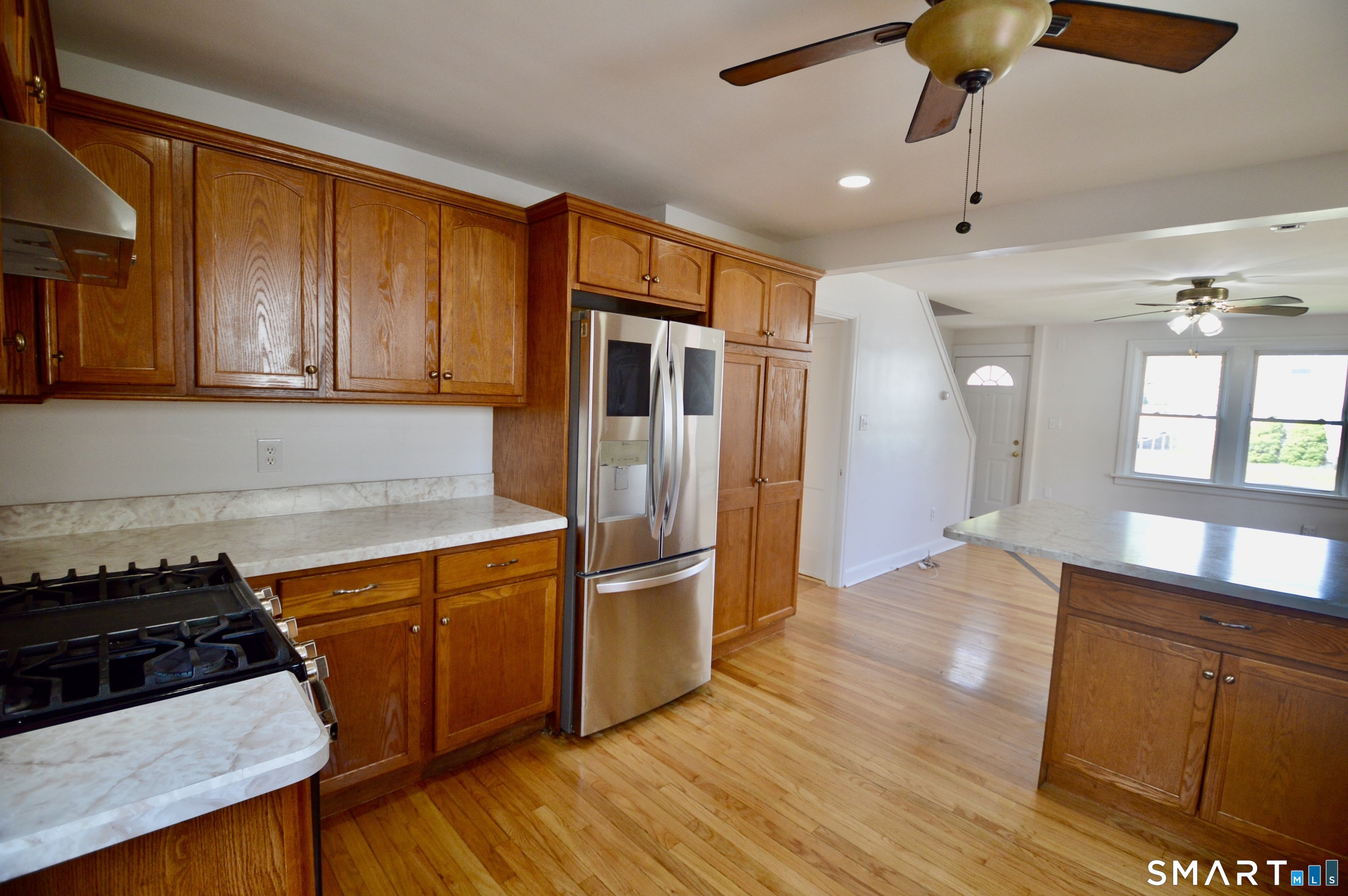 314 Knowlton Street Stratford, CT 06615 - Photo 8 of 26 a kitchen with stainless steel appliances granite countertop a stove a refrigerator and a wooden cabinets
