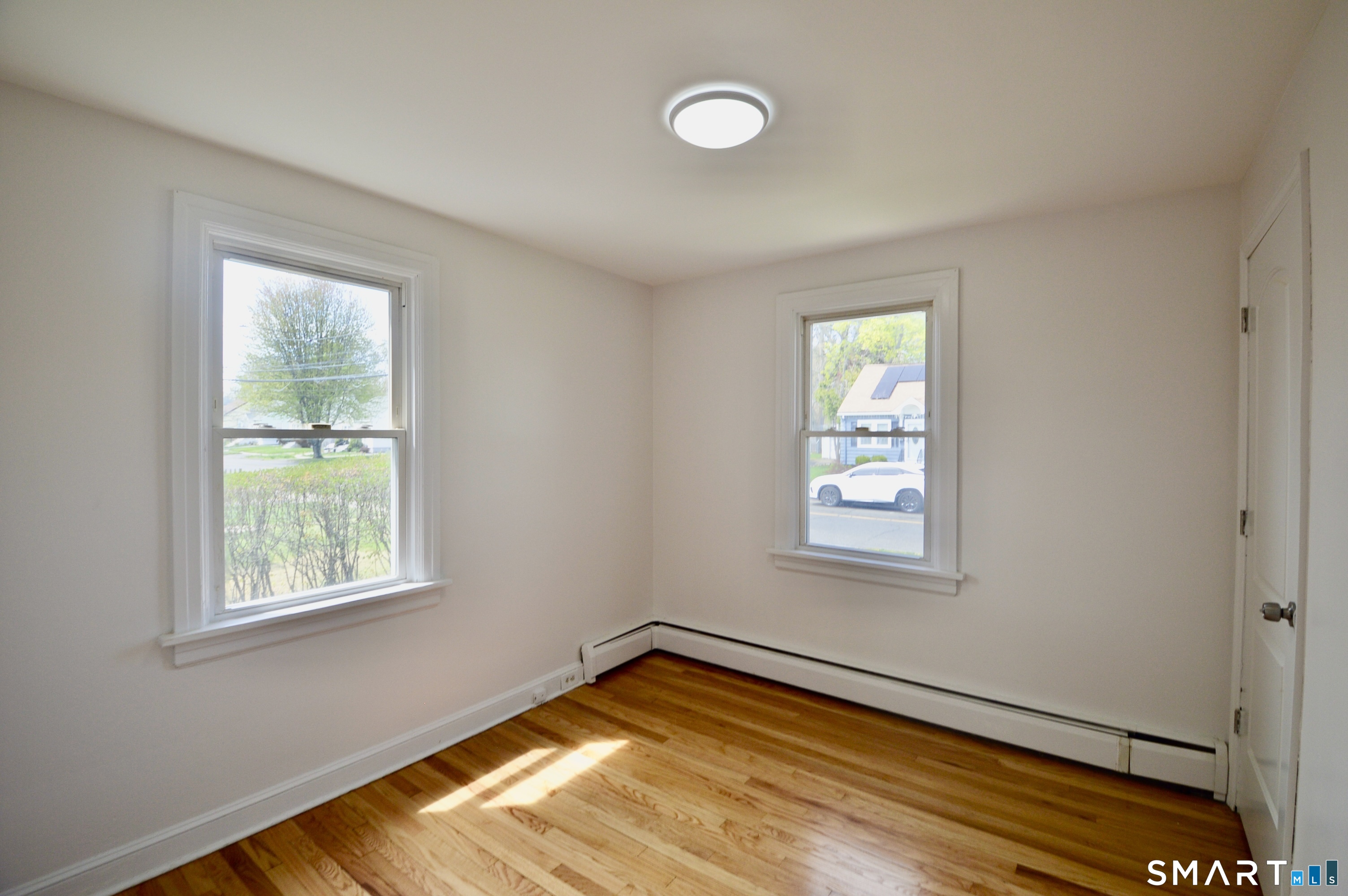 314 Knowlton Street Stratford, CT 06615 - Photo 9 of 26 a view of a room with wooden floor and windows