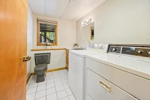 a bathroom with a toilet sink and mirror