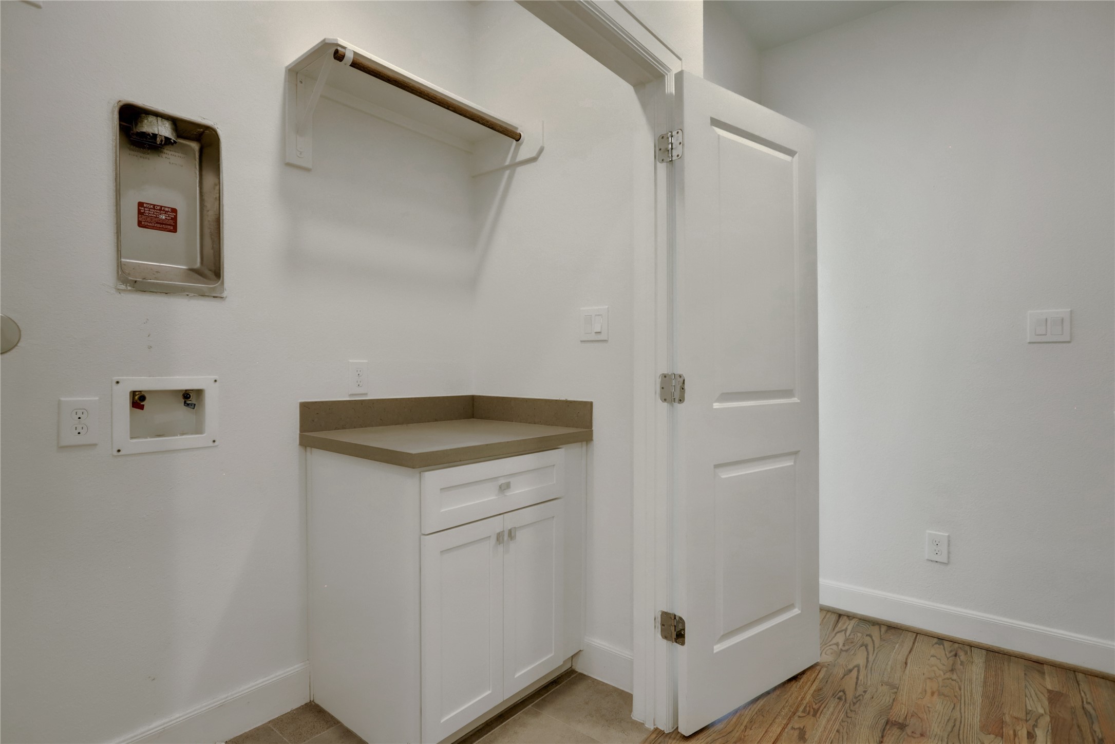 954 West 18th Street Houston, TX 77008 - Photo 22 of 30 Double doors open to a central laundry room with a brand new washer and dryer (not pictured), plus extra storage and a folding countertop, for all of your laundry needs.