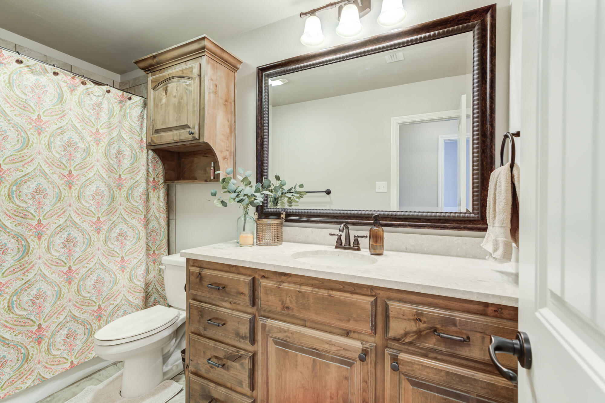 4003 128th Street Lubbock, TX 79423 - Photo 11 of 16 a bathroom with a sink vanity mirror and toilet