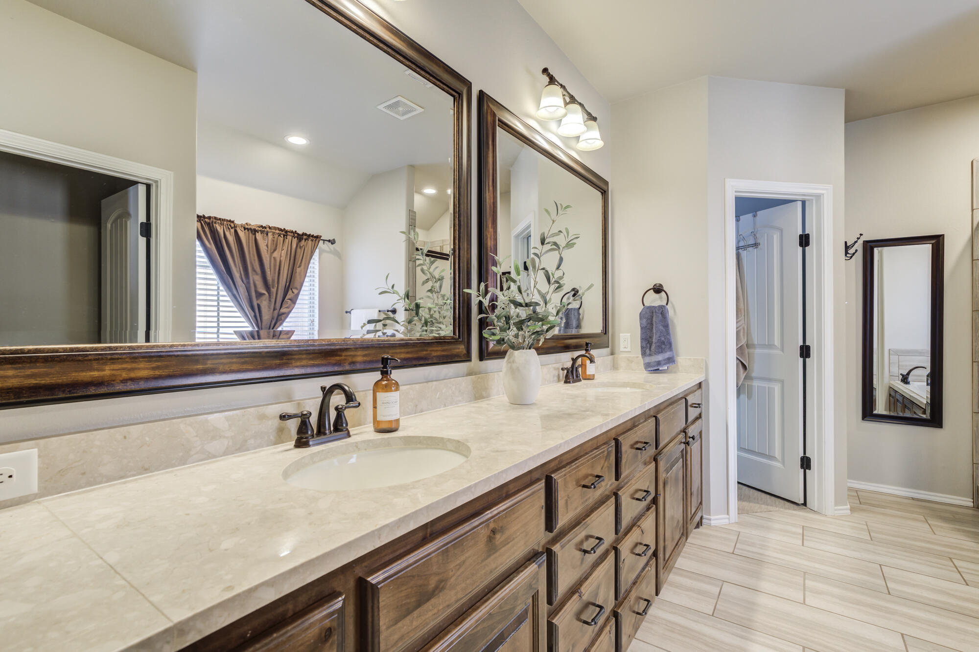 4003 128th Street Lubbock, TX 79423 - Photo 14 of 16 a bathroom with a sink and a mirror