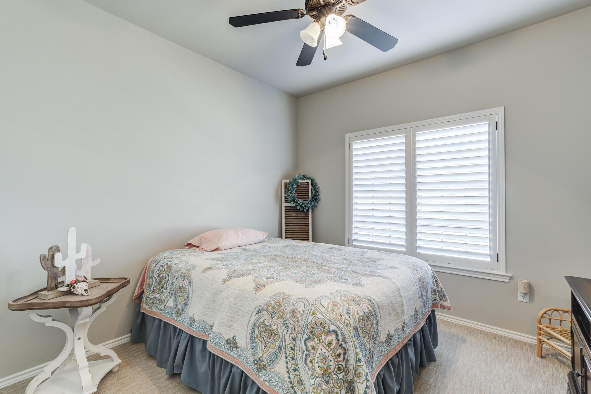 4003 128th Street Lubbock, TX 79423 - Photo 9 of 16 a bedroom with a bed and a chandelier