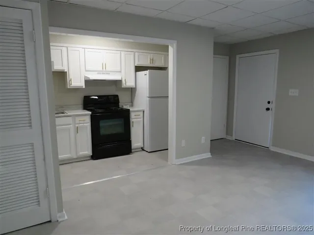 a kitchen with stainless steel appliances granite countertop a refrigerator and a stove