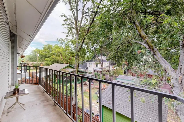 a view of a balcony with wooden floor and fence