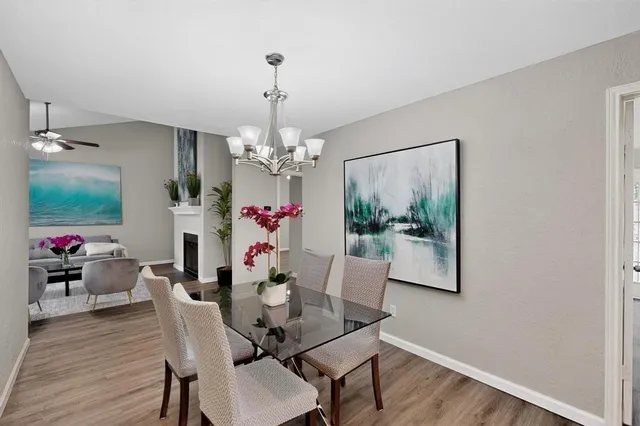 a view of a dining room with furniture wooden floor and chandelier