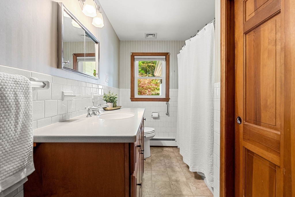 371 Longley Road Groton, MA 01450 - Photo 14 of 33 a bathroom with a sink and a mirror