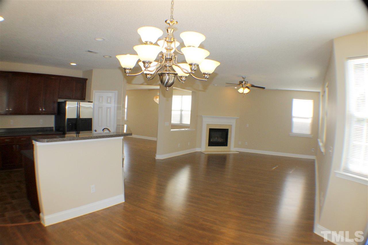 2856 Roundleaf Court Raleigh, NC 27604 - Photo 11 of 24 a view of a room with wooden floor and chandelier