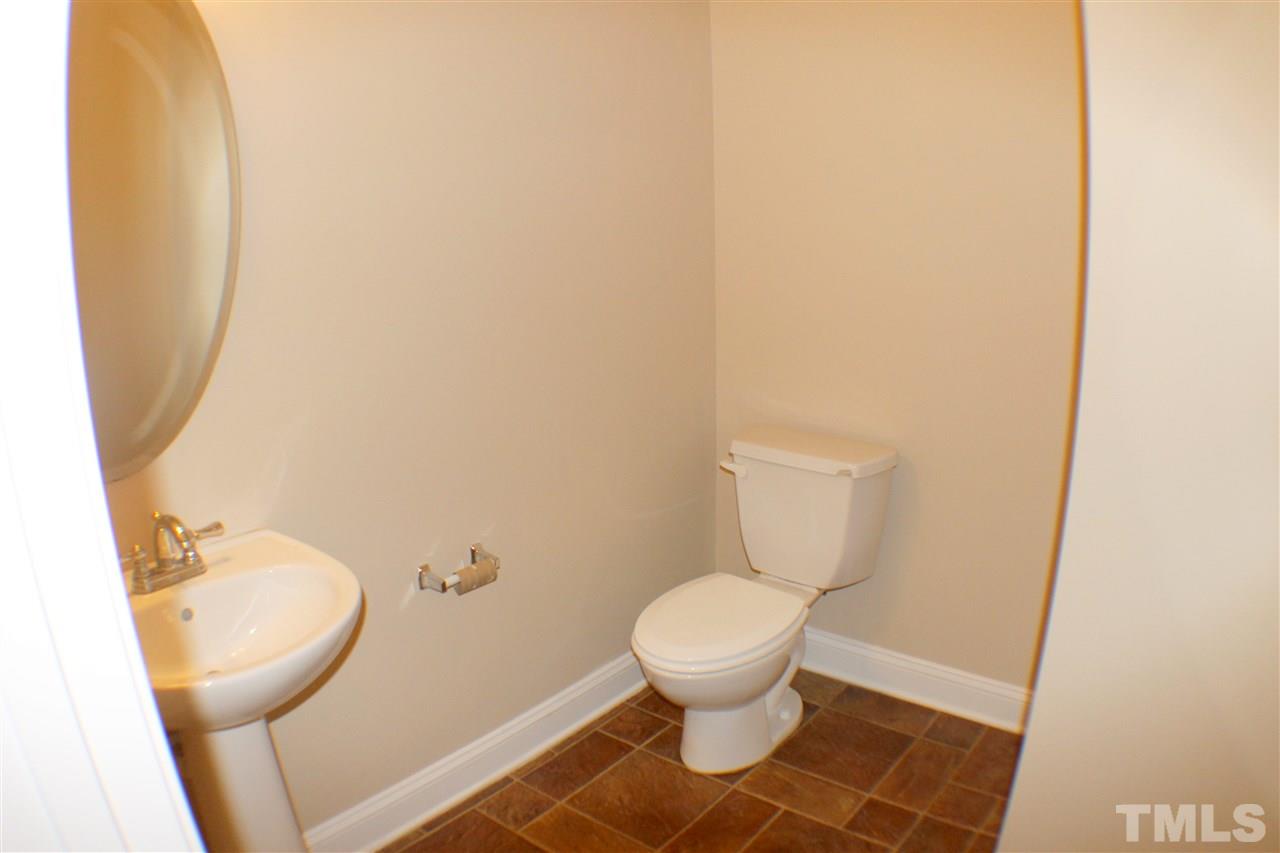 2856 Roundleaf Court Raleigh, NC 27604 - Photo 15 of 24 a white toilet sitting next to a small sink