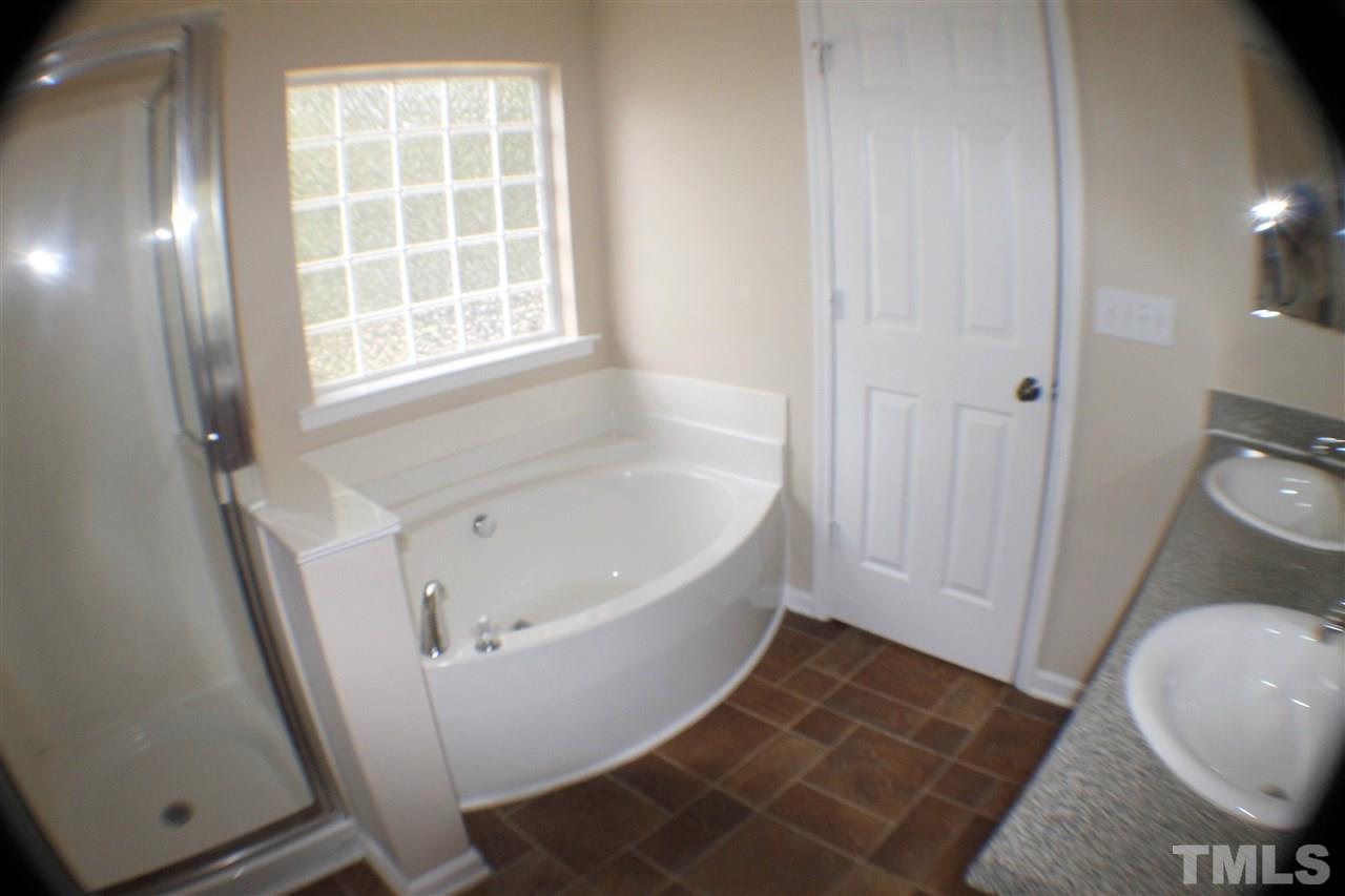 2856 Roundleaf Court Raleigh, NC 27604 - Photo 21 of 24 a white bath tub sitting next to a toilet