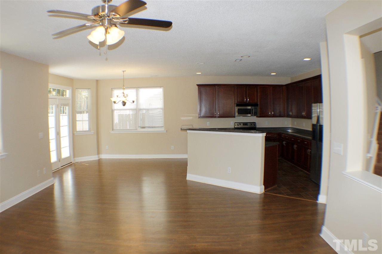 2856 Roundleaf Court Raleigh, NC 27604 - Photo 8 of 24 a kitchen with stainless steel appliances granite countertop a stove top oven a sink and dishwasher with wooden floor